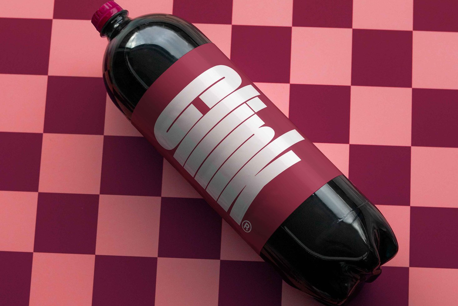 Soda bottle mockup with bold typography on a pink checkered background perfect for graphic design projects packaging concepts and branding presentations