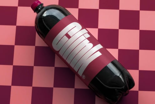 Soda bottle mockup with bold typography on a pink checkered background perfect for graphic design projects packaging concepts and branding presentations