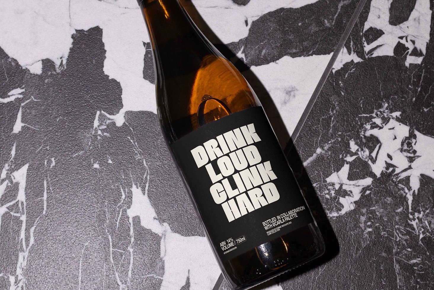Brown glass bottle on black and white marble, label showing bold sans-serif font. Ideal for product mockups, branding, packaging design templates.
