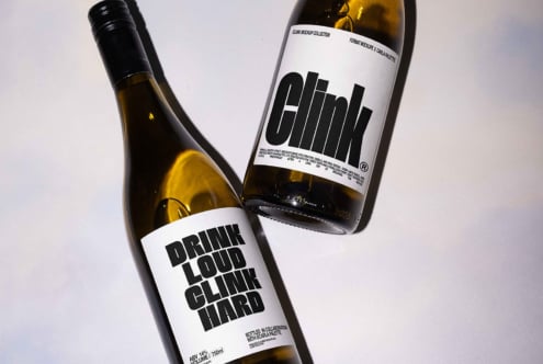 Wine bottle mockup featuring bold black typography on white labels. Ideal for designers seeking realistic product presentation and label design inspiration.