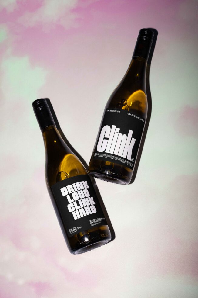 Two wine bottle mockups on a pastel background featuring bold typography design. Perfect for designers seeking unique graphic templates for branding.