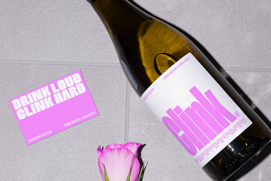 Magenta wine label mockup on bottle with matching neon pink business card, pink rose