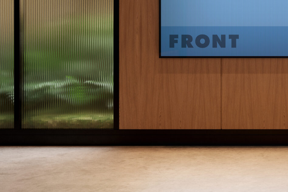 Modern office mockup with wooden panel textures, frosted glass window, and blue rectangular sign. Ideal for workspace or interior design presentations.