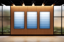 Retail display with three blue gradient frame mockups mounted on wood backdrop