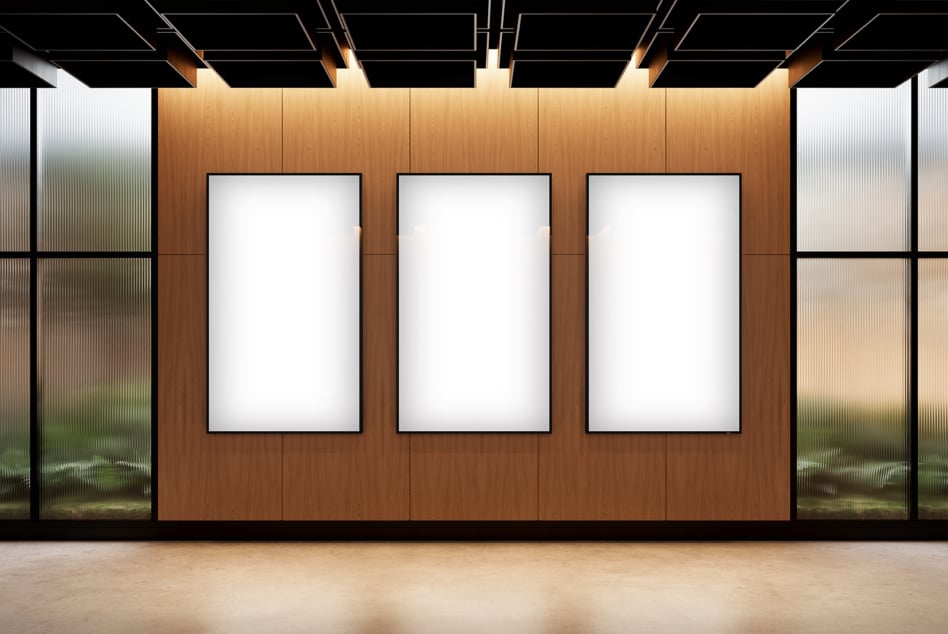 Minimalist showroom with three white poster frames on wood wall, glass sides