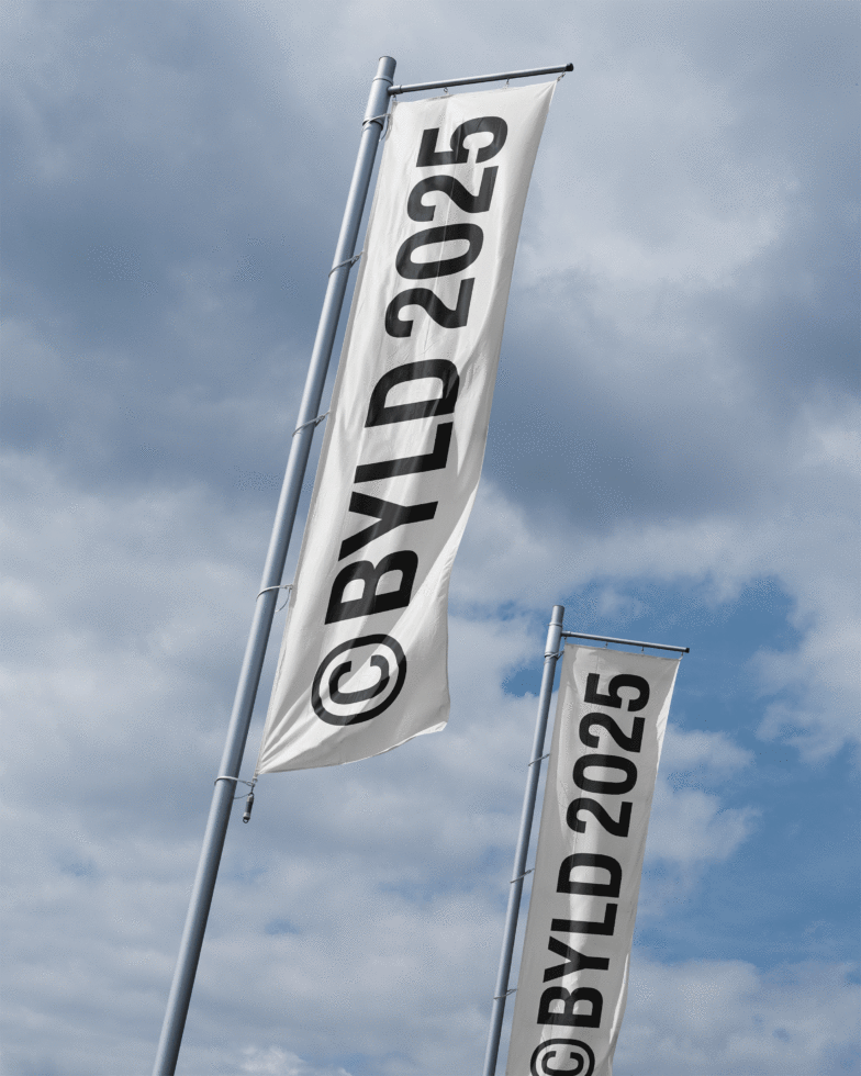Vertical flag banners marked BYLD 2025 against a cloudy sky perfect for graphic design templates or branding mockups for creative designers