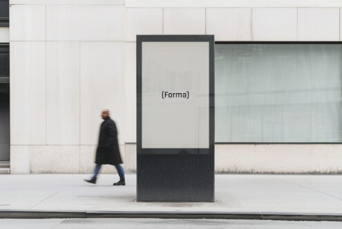 Outdoor signage mockup on an urban street with a minimalist design. Ideal for branding projects, featuring a person walking in the background.