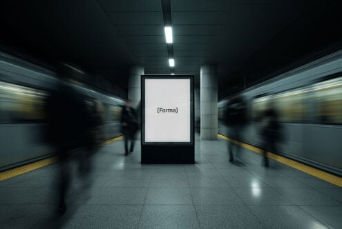 Mockup of a blank poster in a modern subway station with blurred passengers and trains. Ideal for urban design projects and advertising templates.