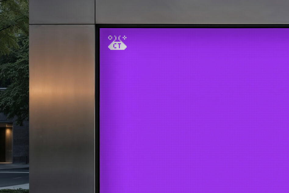 Digital billboard mockup with a purple display and retro graphic icon in an urban setting ideal for showcasing branding or advertising designs.