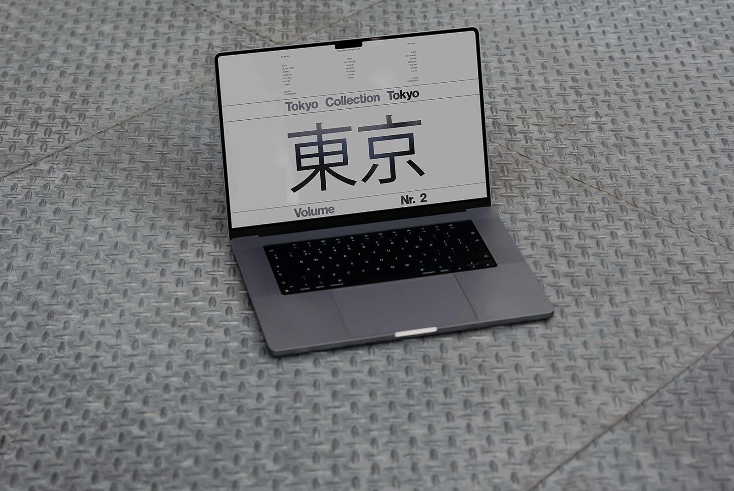 Laptop displaying Tokyo font collection on a metal floor. Ideal for designers seeking unique typography mockups and design templates. High-res graphic asset.