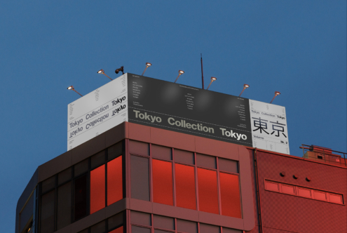 Modern building facade featuring a Tokyo-themed billboard mockup illuminated against a clear sky. Ideal for designers seeking urban signage templates.