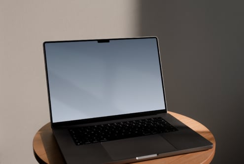 Laptop mockup on wooden table with blank screen ideal for showcasing digital designs templates for designers perfect for mockups or graphic presentations