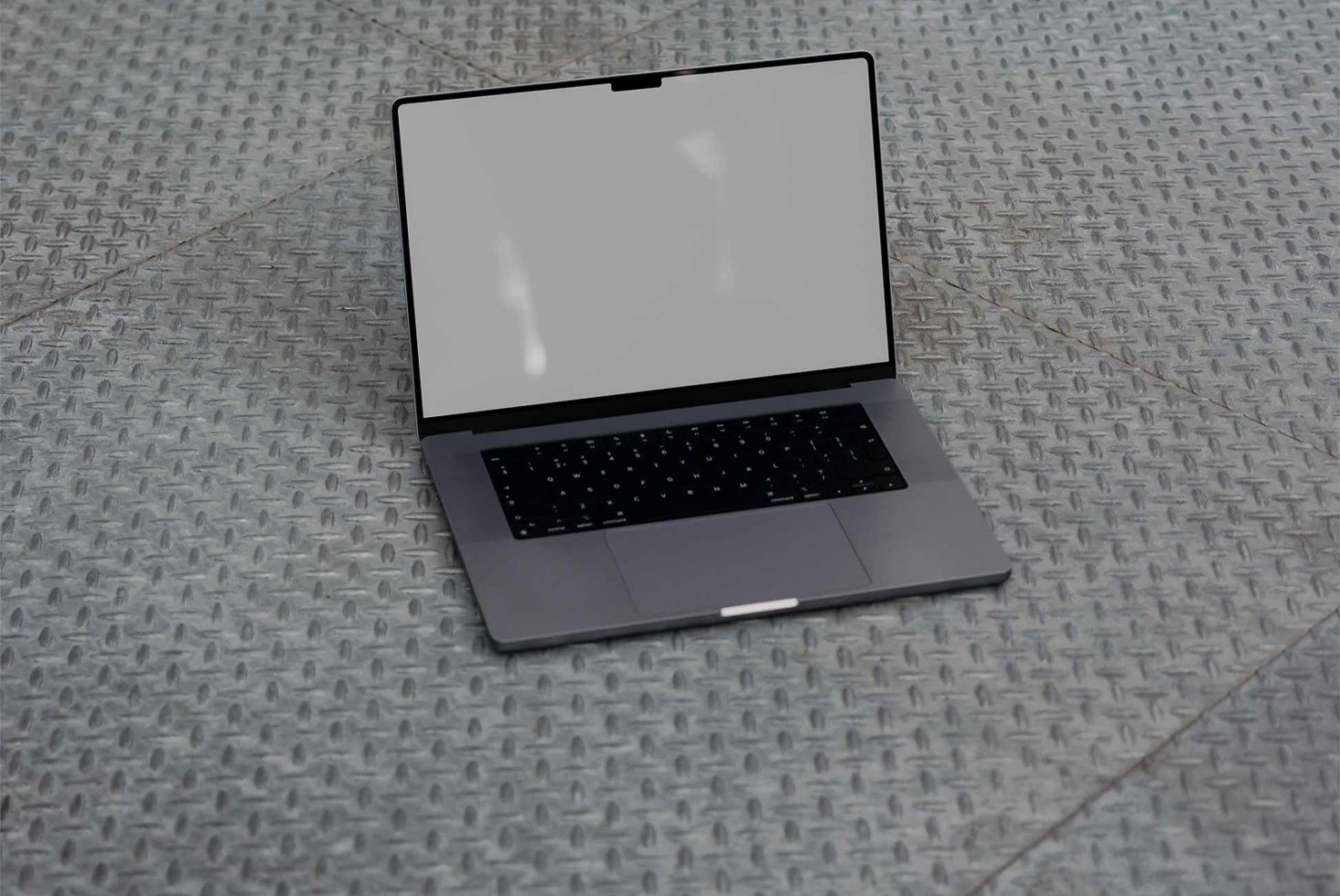 Laptop mockup on textured metal floor showing blank screen for design presentation features workspace branding technology digital asset for designers