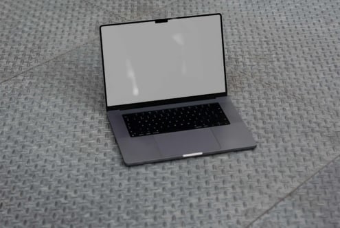 Laptop mockup on textured metal floor showing blank screen for design presentation features workspace branding technology digital asset for designers
