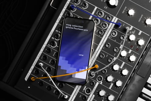 iPhone 14 Pro mockup laying on synthesizer with cables modern design template for digital assets aimed at designers in graphics and mockups categories