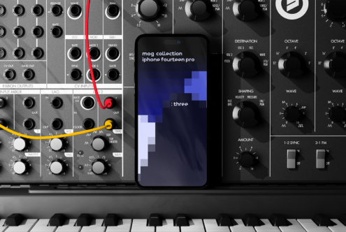 iPhone 14 Pro mockup displayed on a modular synthesizer, featuring a digital abstract design. Keywords: mockup, iPhone, synthesizer, design asset.