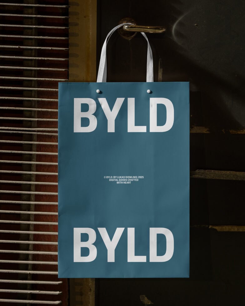 Mockup of a hanging turquoise paper bag with bold white BYLD text perfect for branding design presentations and showcasing packaging concepts