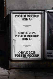 White poster mockup in metal frame mounted on weathered brick