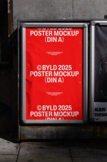 Red poster mockup in aluminum frame on grungy urban street wall