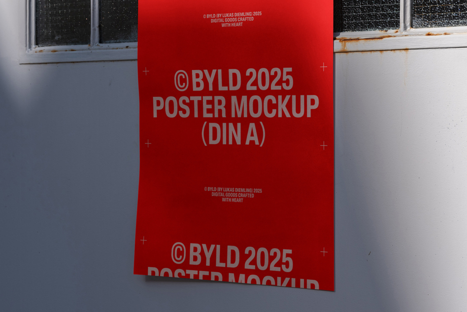 Bright red DIN A poster mockup with bold gray text hung on weathered wall