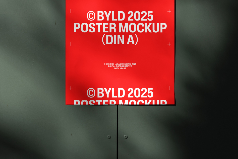 Red DIN A poster mockup on sage green wall showing bold white typography