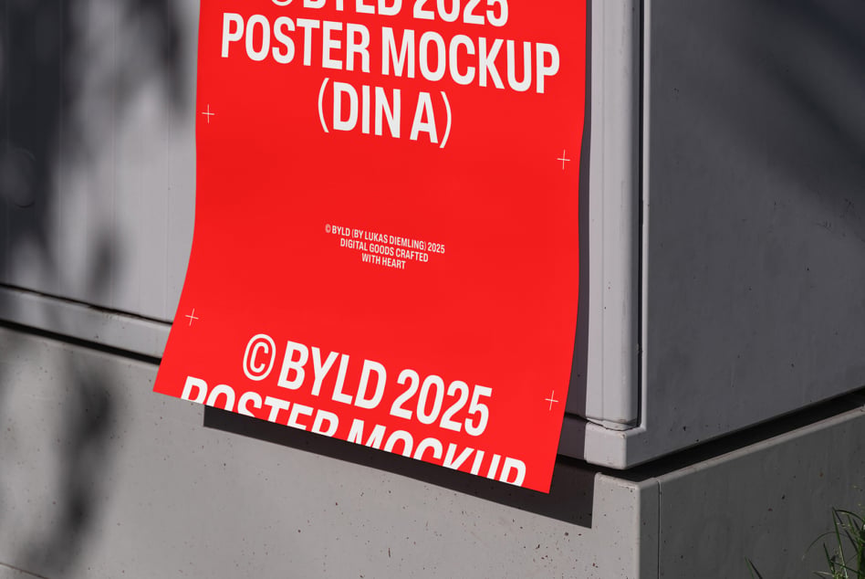Red DIN A poster mockup leaning against concrete wall indoors