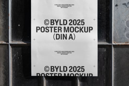 Poster mockup template showing blank paper against a textured wall. Ideal for showcasing design work. Keywords: poster, mockup, template, design.