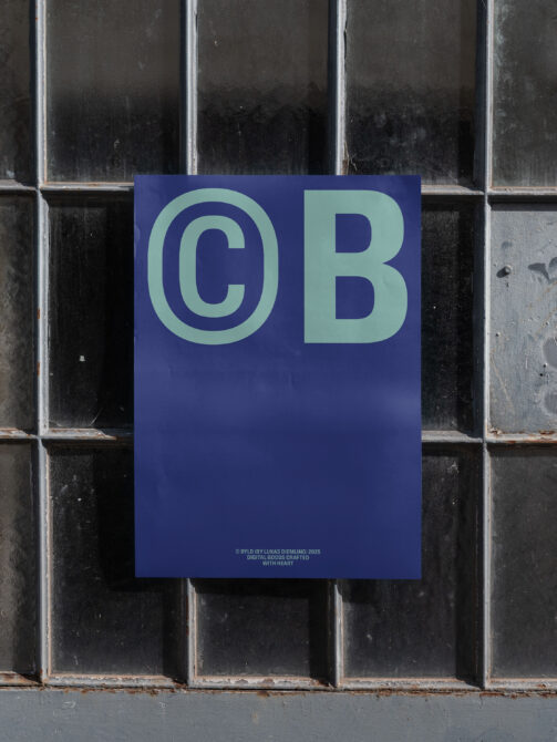 Navy poster with mint CB letters mounted on dark brick wall
