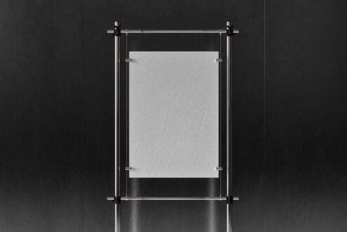 Minimalist poster mockup featuring a blank white sheet suspended on sleek metal rods against a dark background ideal for designers and graphic artists.