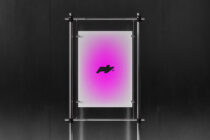 Chrome frame stand holding magenta gradient poster with black logo