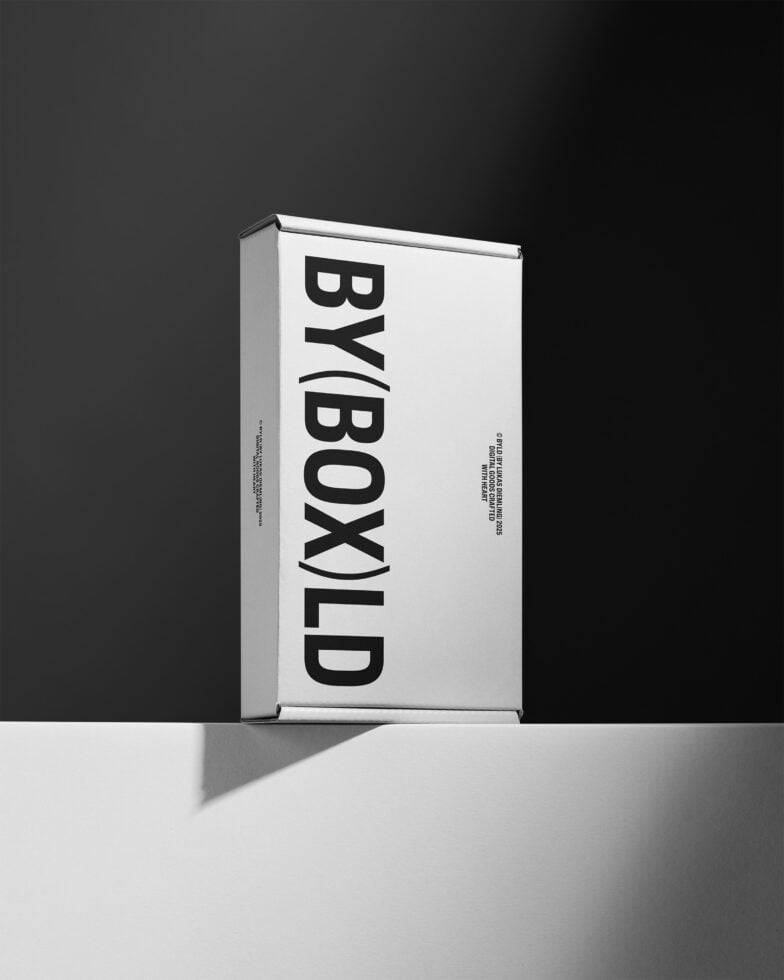 Minimalist packaging mockup with bold black typography on white box against dark background. Ideal for branding presentation and design showcase.