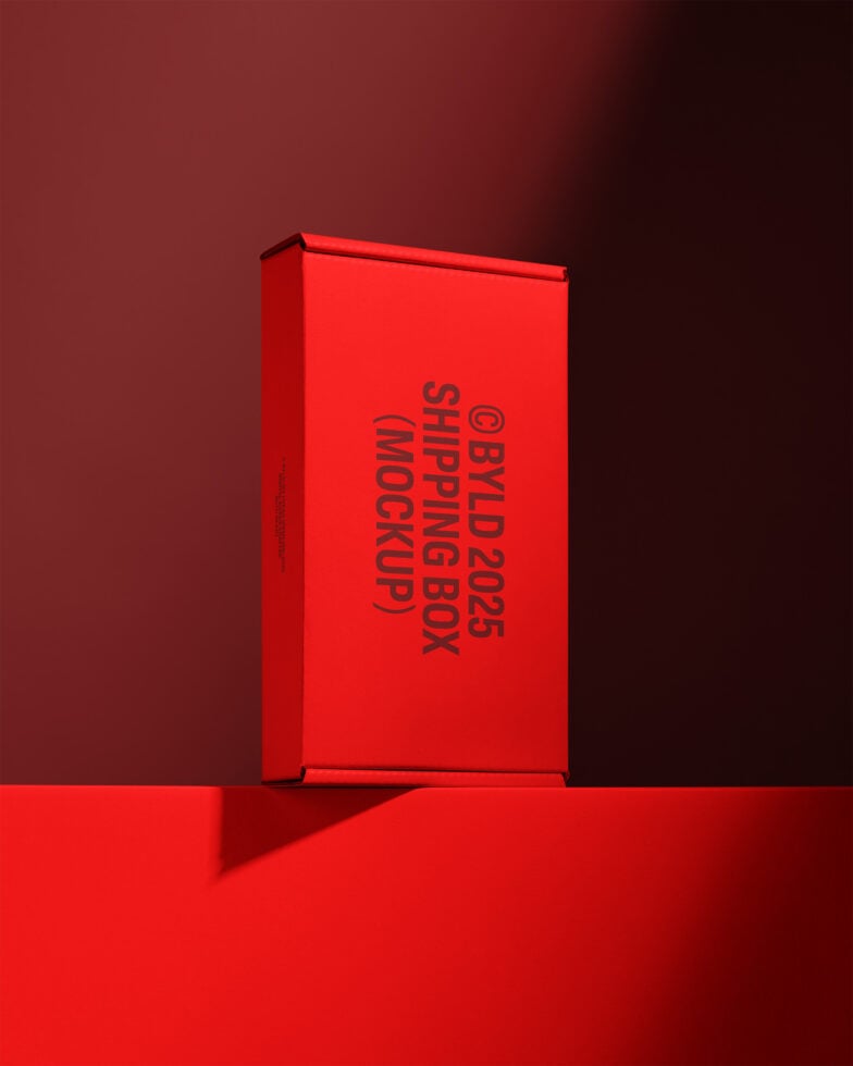 Red shipping box mockup for designers on a colored backdrop ideal for showcasing packaging designs or branding in marketing and design projects.