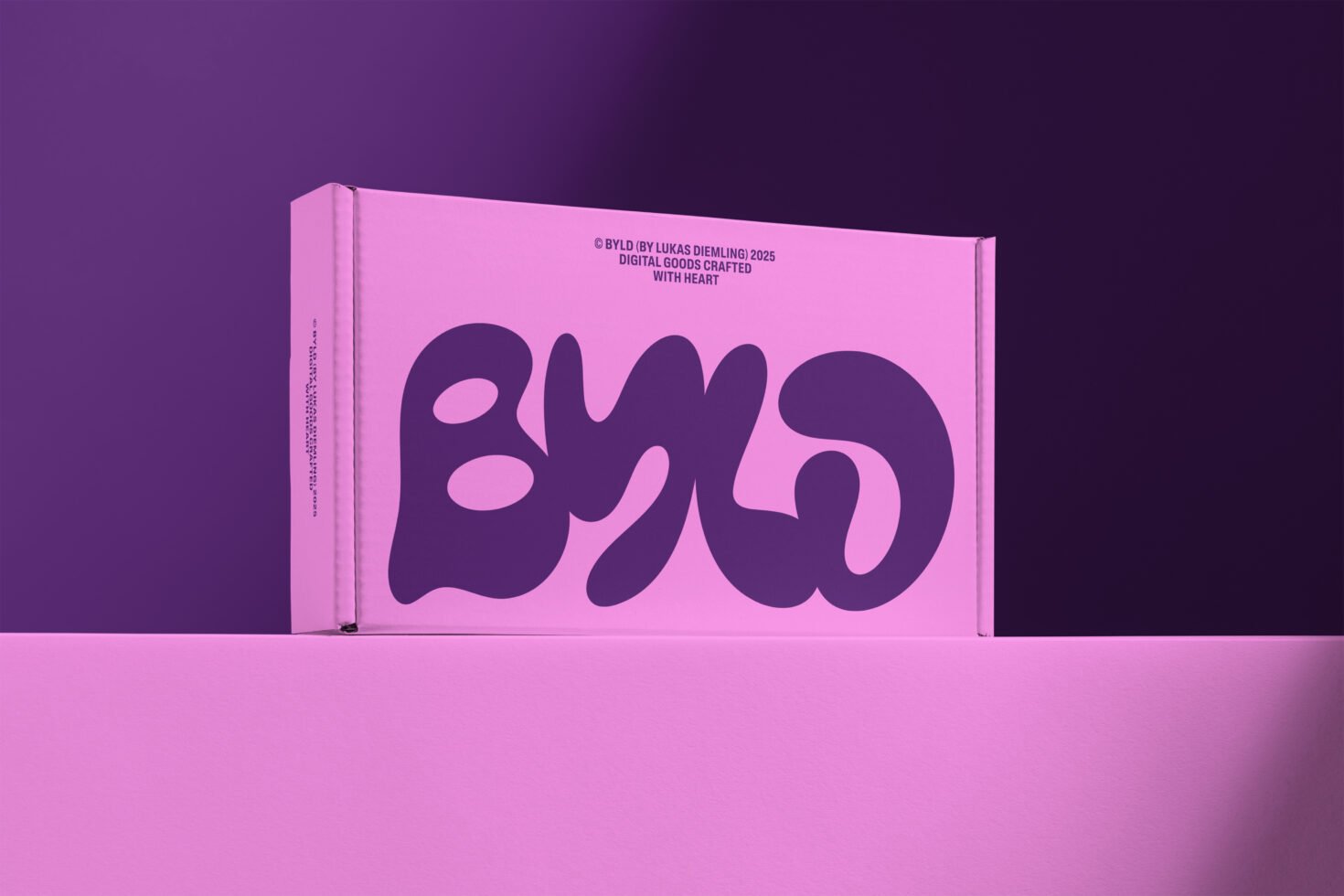 Pink packaging box with bold purple typography set against a purple background; ideal for mockup presentations for designers in digital goods.