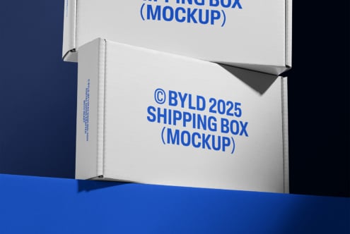 Shipping box mockup 2025 featuring two stacked cardboard boxes with bold blue text on a blue background ideal for packaging design presentations.