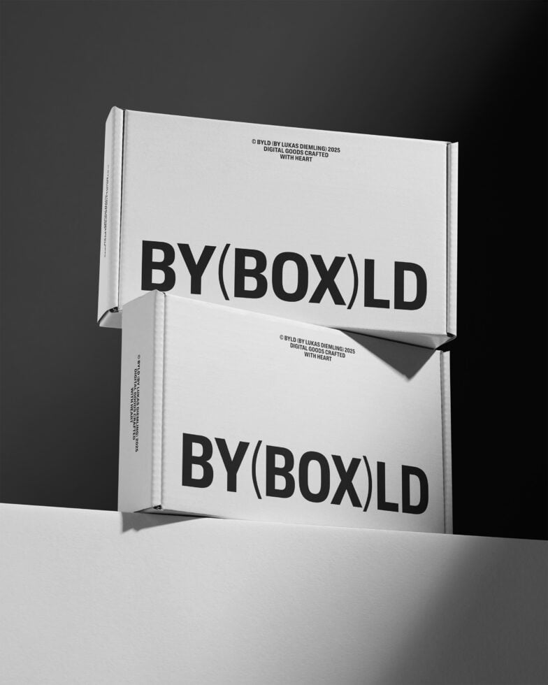 Mockup of two stacked cardboard boxes in grayscale lighting, displaying bold text for packaging design, ideal for graphic designers' resources.