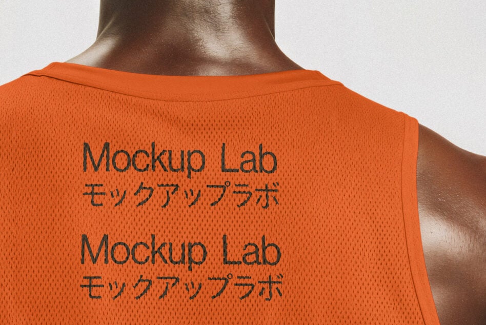 Orange mesh jersey mockup featuring bold text Mockup Lab in English and Japanese. Ideal for designers seeking sports apparel graphics and templates.