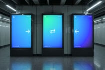 Three hanging digital screens in subway station showing directional arrows with color gradients