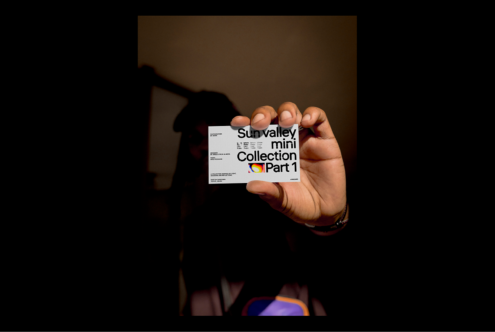 Person holds a business card with bold typography Sun Valley Mini Collection Part 1 suitable for designers. Ideal for mockup template and font projects.
