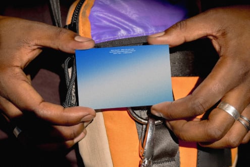 Hands holding a business card mockup with gradient design, ideal for designers seeking modern templates. Perfect for showcasing branding assets.