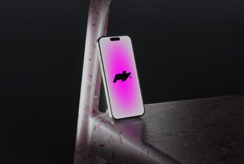 Smartphone mockup on a textured surface with a vibrant pink gradient screen. Ideal for showcasing app designs and digital assets. Perfect for designers.