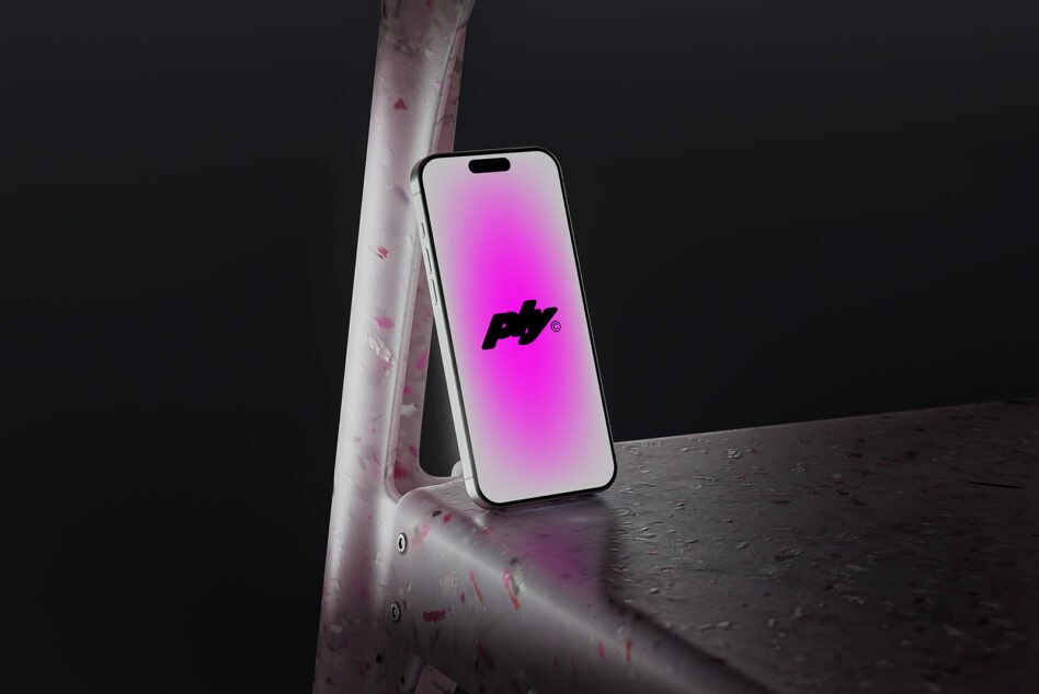 White phone showing pink gradient logo leaning on pink pole dark background