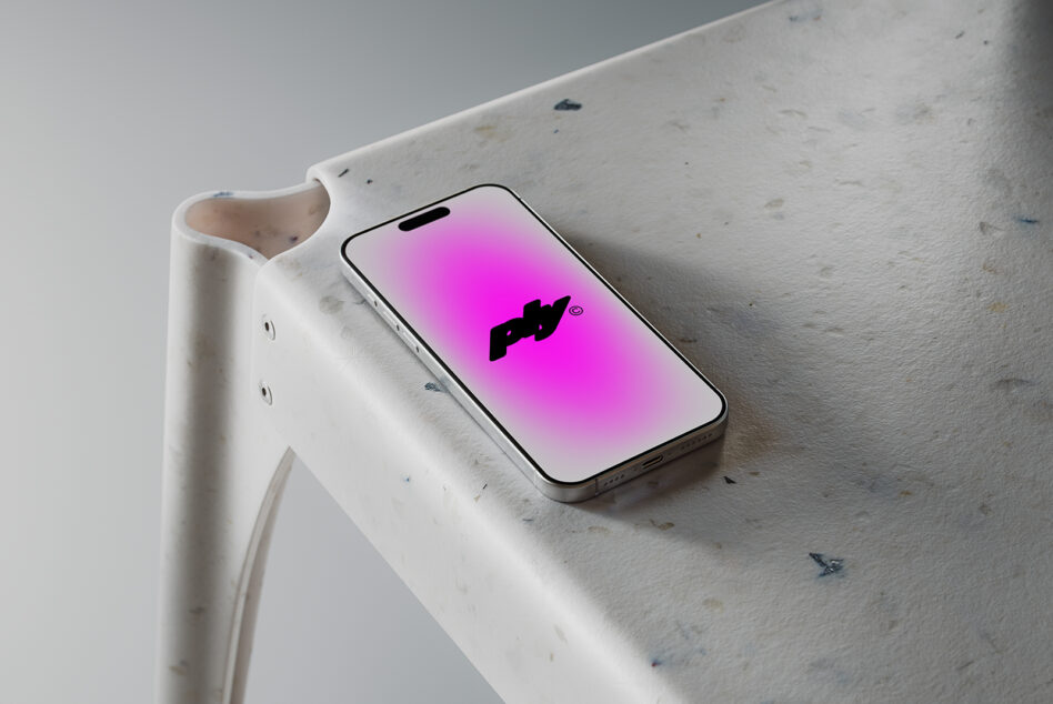 Silver iPhone displaying pink gradient with black logo on marble shelf
