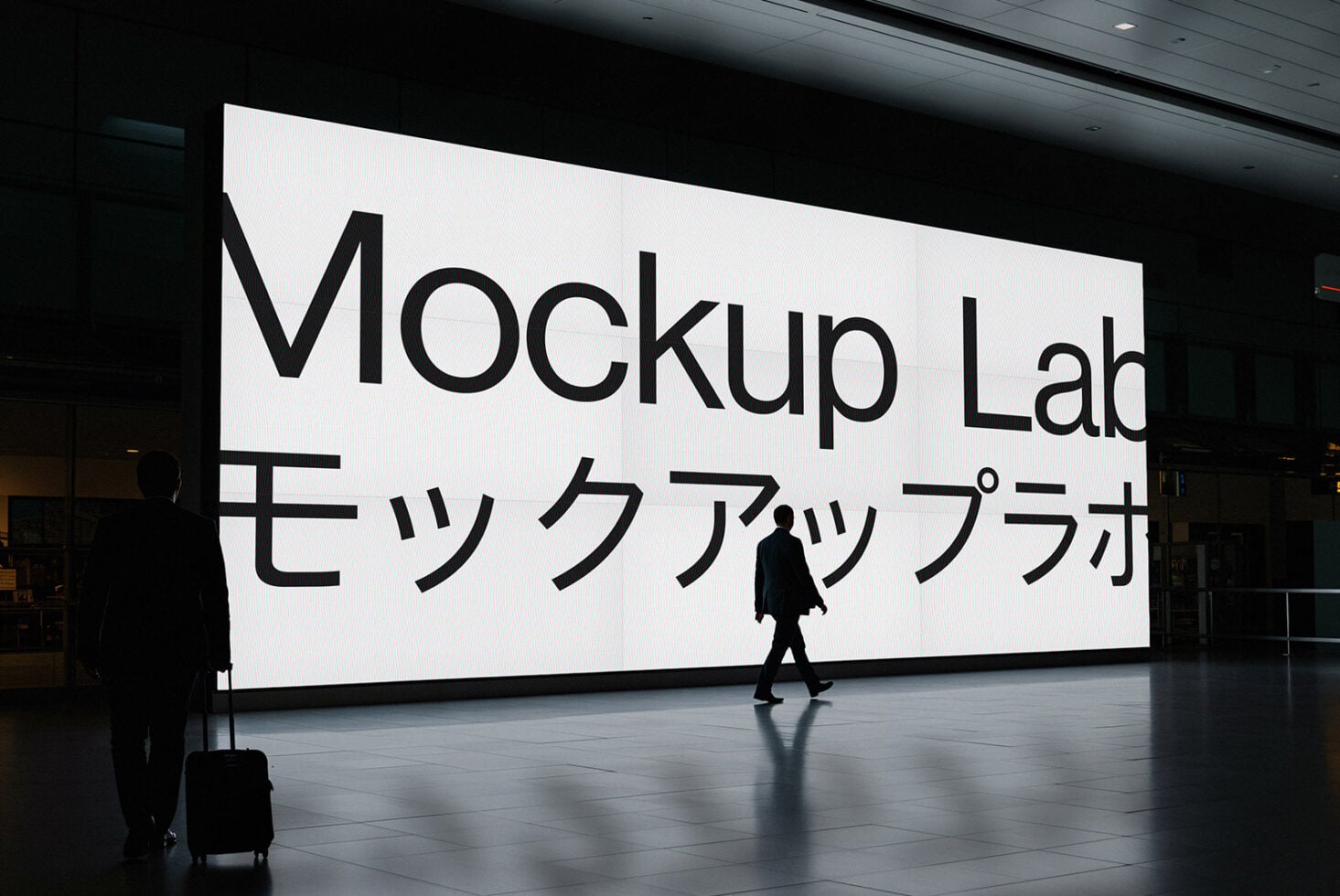 Person walking by large terminal display with Mockup Lab branding in English, Japanese text