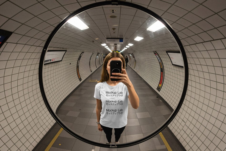 Mockup Lab white tee on model in tunnel taking phone mirror self-portrait