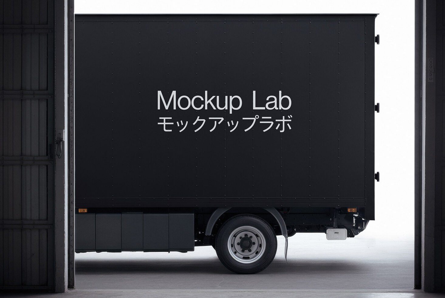 Box truck mockup with Japanese text in a warehouse setting. Ideal for showcasing design projects. Keywords: truck mockup, Japanese font, graphic design.