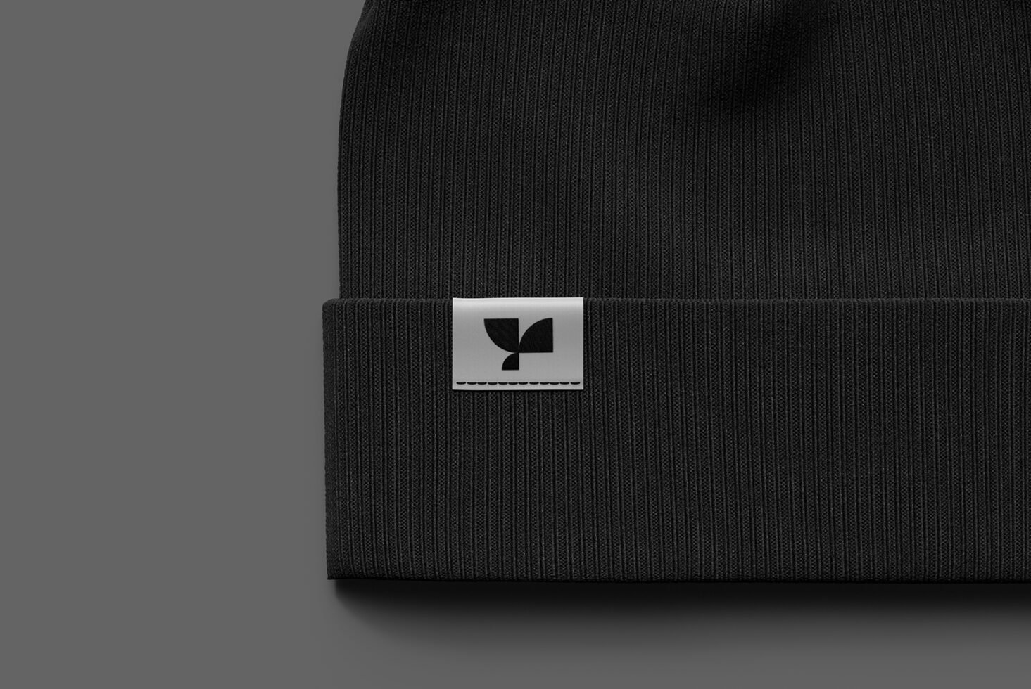 Black beanie mockup with stitched label design centered on the cuff suitable for branding presentations and apparel mockup projects for designers