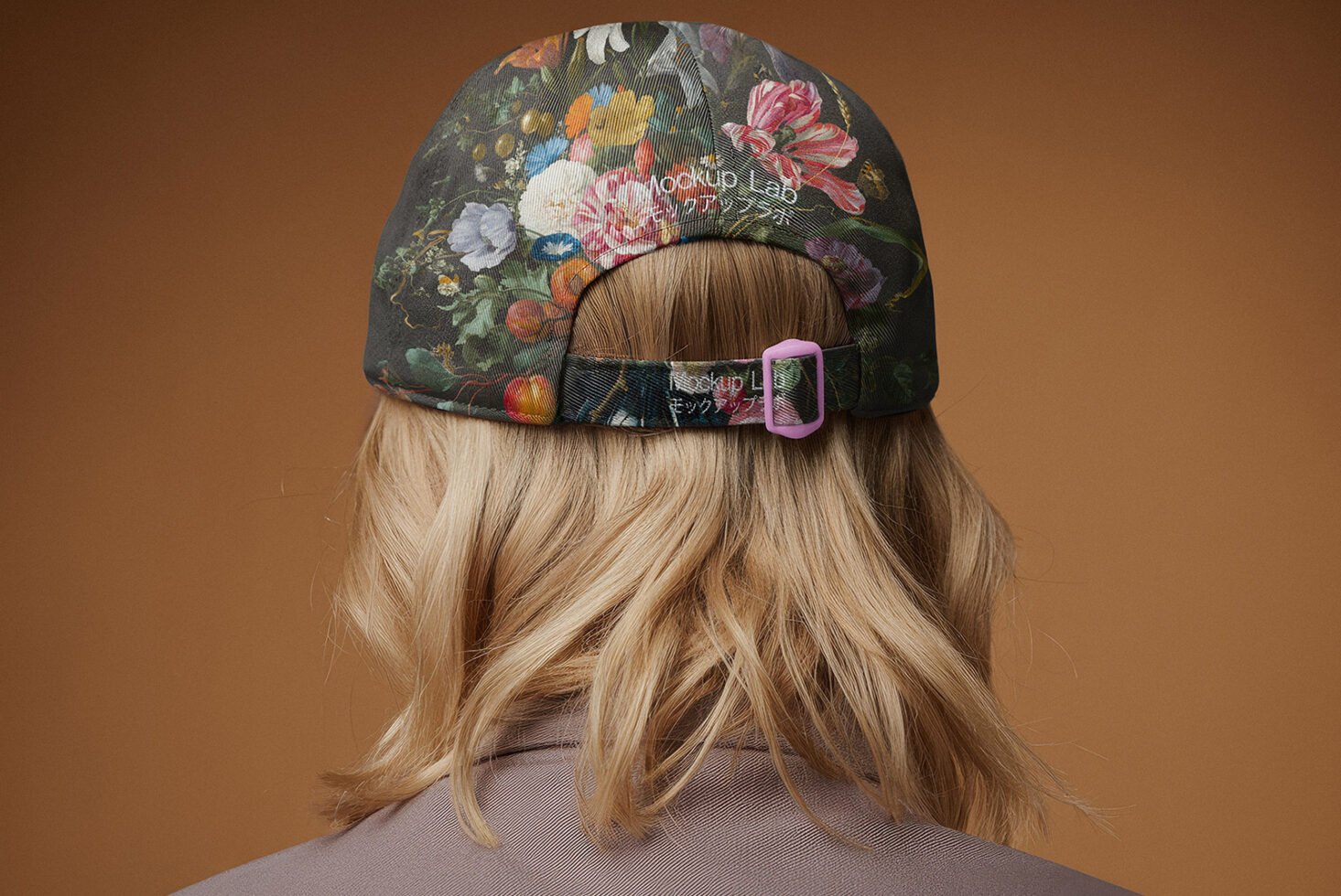 Floral cap design mockup featuring a person with long blonde hair wearing a fabric cap with colorful flower patterns and adjustable strap. Fashion template.