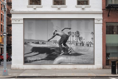 Street building with large skateboarder photo wall mockup. Ideal for designers, urban graphics projects. Realistic presentation in city setting.