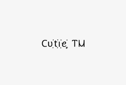 Cutie TM typeface display with decorative dots in minimalist serif style