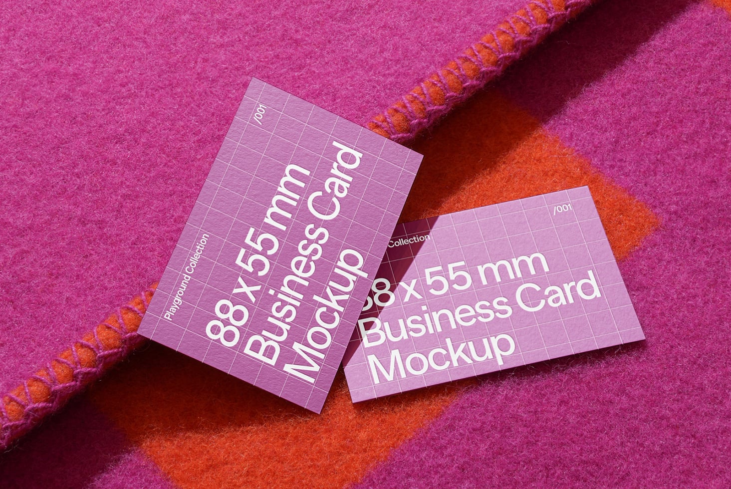 Two lavender business cards with white text on pink fabric background